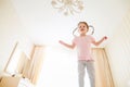 Cute little girl in bedroom jumping on a bed Royalty Free Stock Photo