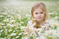 Cute little girl in big camomile meadow Royalty Free Stock Photo