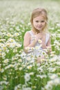 Cute little girl in big camomile meadow Royalty Free Stock Photo