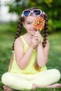 Cute little girl with big colorful lollipop. Royalty Free Stock Photo