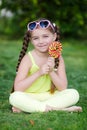 Cute little girl with big colorful lollipop. Royalty Free Stock Photo