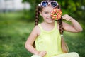 Cute little girl with big colorful lollipop. Royalty Free Stock Photo