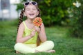 Cute little girl with big colorful lollipop. Royalty Free Stock Photo