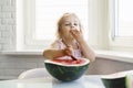 little girl eating watermelon in the kitchen Royalty Free Stock Photo