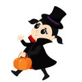 A cute little girl with black hair dressed in a vampire or Count Dracula costume walks merrily with a candy pumpkin basket.