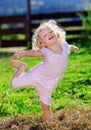 Cute little girl with blond curly hair playing