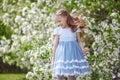 Cute little girl in blooming apple tree garden at spring Royalty Free Stock Photo