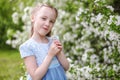 Cute little girl in blooming apple tree garden at spring Royalty Free Stock Photo