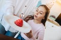 Cute little girl blowing out candles on birthday cake on kitchen with mother. Celebrating birthday at home. Royalty Free Stock Photo