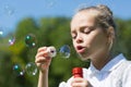 Cute little girl blowing soap bubbles Royalty Free Stock Photo