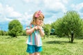 Cute little girl is blowing a soap bubbles.Fashionable baby girl in outdoors park, active games, runs Royalty Free Stock Photo