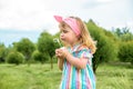 Cute little girl is blowing a soap bubbles.Fashionable baby girl in outdoors park, active games, runs Royalty Free Stock Photo