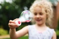 Cute little girl is blowing a soap bubbles and having fun Royalty Free Stock Photo