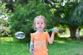 Cute little girl blowing soap bubbles in nature Royalty Free Stock Photo