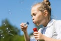 Cute little girl blowing soap bubbles Royalty Free Stock Photo