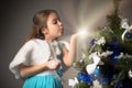 Cute little girl in a blue dress holds a gift Royalty Free Stock Photo