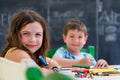 Cute little girl and boy drawing and painting with colorful markers pens at kindergarten. Creative activities kids club Royalty Free Stock Photo