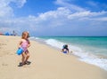 Cute little girl and boy play with water on beach Royalty Free Stock Photo