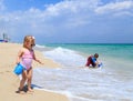 Cute little girl and boy play with water on beach Royalty Free Stock Photo