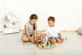 Cute little girl and boy playing with toys by the home Royalty Free Stock Photo