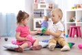 Cute little girl and boy playing with toys in playroom Royalty Free Stock Photo