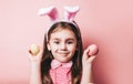 Cute little girl with bunny ears on pink background Royalty Free Stock Photo
