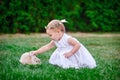 Cute little girl with a bunny rabbit has a easter at green grass Royalty Free Stock Photo