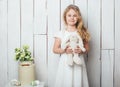 Cute little girl with a bunny rabbit toy on white wood background Royalty Free Stock Photo