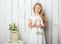 Cute little girl with a bunny rabbit toy on white wood background Royalty Free Stock Photo