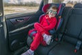 Cute little girl in car safety seat. Baby security during driving Royalty Free Stock Photo