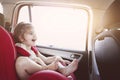 Cute little girl in car safety seat smiling Royalty Free Stock Photo