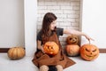Cute little girl with carving pumpkins. Happy family preparing for Halloween. Funny kid at home Royalty Free Stock Photo