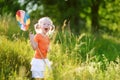 Cute little girl catching butterflies and bugs with her scoop-net Royalty Free Stock Photo