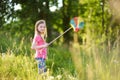 Cute little girl catching butterflies and bugs with her scoop-net Royalty Free Stock Photo