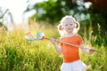 Cute little girl catching butterflies and bugs with her scoop-net Royalty Free Stock Photo