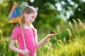 Cute little girl catching butterflies and bugs with her scoop-net Royalty Free Stock Photo