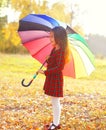 Cute little girl child with colorful umbrella in sunny autumn day looking view Royalty Free Stock Photo