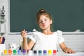 Cute little girl child painting with paints color and brush. Little artist painting, drawing art. Royalty Free Stock Photo