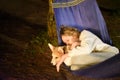 Cute little girl child sleeping in hammock and holding a corgi dog together in camping trip Royalty Free Stock Photo