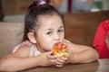 Cute little girl Children enjoy eating pizza in classroom school . kid hungry Royalty Free Stock Photo