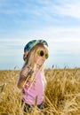 Cute little girl in a colorful hat and sunglasses Royalty Free Stock Photo