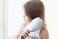 Cute little girl combing her hair with comb Royalty Free Stock Photo