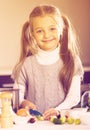 Cute little girl cooking veggies in kitchen