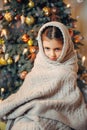Cute little girl covered in warm scarf waiting for Christmas Royalty Free Stock Photo