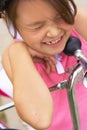 Cute little girl cries sitting on the ground after falling off her bike. Child getting hurt while riding a bicycle. Royalty Free Stock Photo