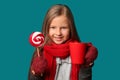 Cute little girl with cup of hot chocolate and lollipop on color background Royalty Free Stock Photo