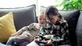 Cute little girl and cute boy playing a competitive video game on a smartphone, fighting over the game Royalty Free Stock Photo