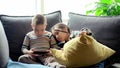 Cute little girl and cute boy playing a competitive video game on a smartphone, fighting over the game Royalty Free Stock Photo