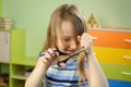 little girl cuts her hair with scissors