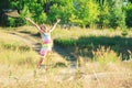 Beautiful little girl Is dancing in the meadow at summer sunset Royalty Free Stock Photo